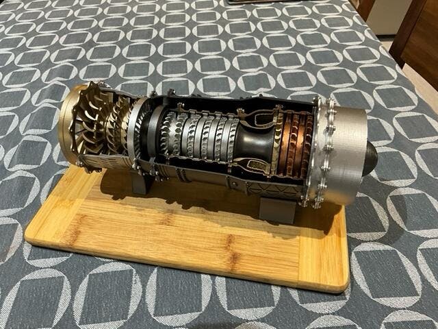 Finished 1:20 WS-15 turbofan model with a cutaway body on a wooden board.