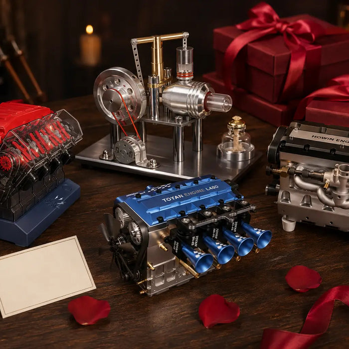 Collection of miniature engine models, including V8, four-cylinder and Stirling engines, arranged with red Valentine’s gift boxes, ribbons and rose petals.