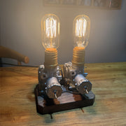 repurposed motorcycle carburetor steampunk table lamp, industrial desk light with vintage filament bulbs, wood base and adjustable metal structure