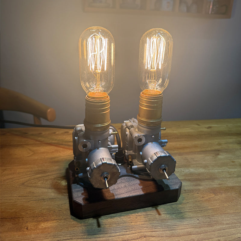 repurposed motorcycle carburetor steampunk table lamp, industrial desk light with vintage filament bulbs, wood base and adjustable metal structure